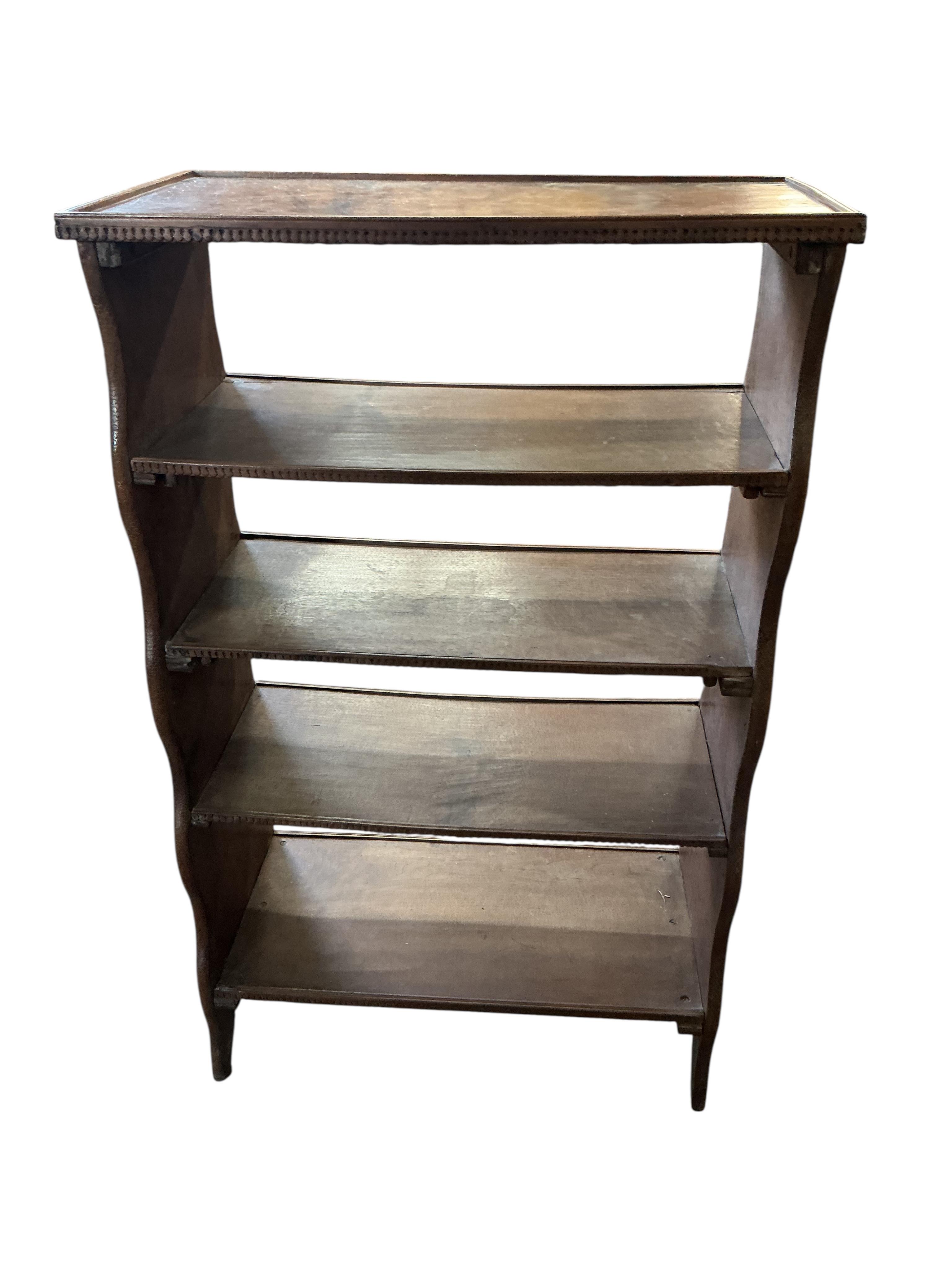 An Indian hardwood open bookcase, width 66cm, depth 34cm, height 107cm